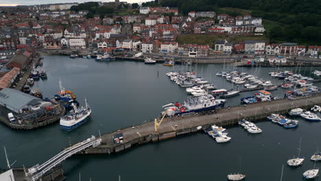 Establishing-Drone-Shot-of-Scarborough-Harbour-with-Fishing-Boat-Entering-Harbour