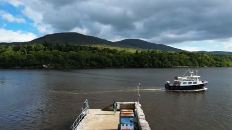 A-sweeping-right-shot-in-4K-drone-of-Kenmare-coastal-boat-tours-leaving-Kenmare-pier-at-times-throughout-the-summer-seven-days-Kenmare-is-on-the-Ring-of-Kerry