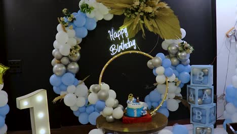 one-year-birthday-decoration-with-white-and-blue-balloons-from-different-angle