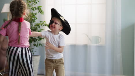 Toddler-boy-in-pirate-costume-attacks-sister-with-toy-sword