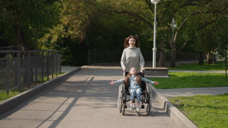 Happy-mother-pushes-daughter-in-wheelchair-running-in-park