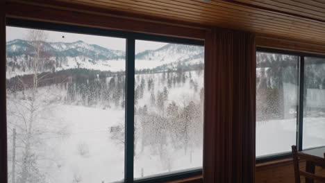 Scenic-winter-landscape-seen-from-big-window-of-hotel-room