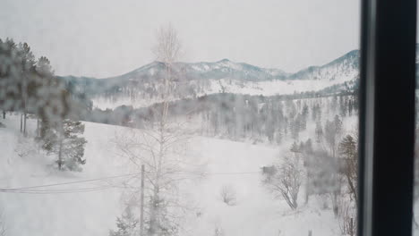 Winter-landscape-with-forestry-mountains-seen-out-window
