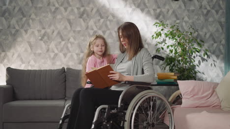 Loving-mom-with-disability-reads-little-daughter-fairytale