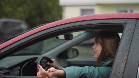Delighted-woman-drives-car-stretching-hand-out-of-window