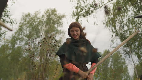 Teenage-girl-holding-spear-defeats-enemy-smiling-gladly