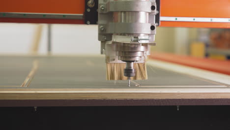 Wood-cutting-lathe-machine-operates-with-plywood-in-workshop