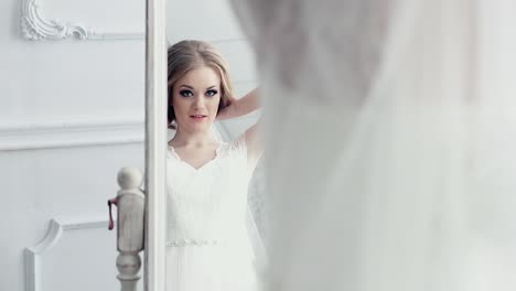 Bride-in-front-of-mirror-corrects-hairstyle-1
