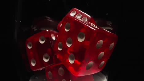 Red-dices-with-white-dots-thrown-into-transparent-glass