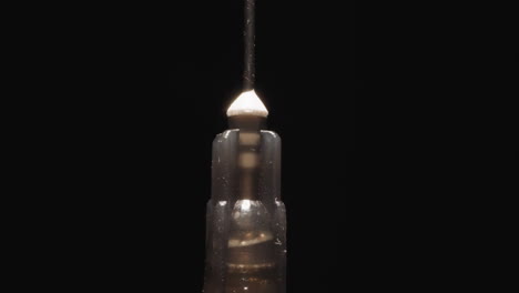 Old-syringe-with-rusty-needle-at-bright-studio-light