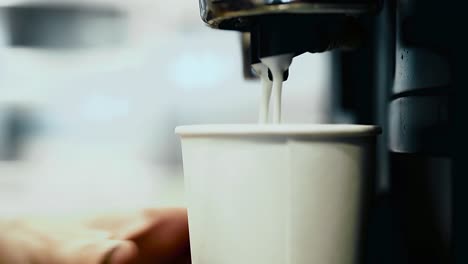 close-coffee-machine-makes-cappuccino