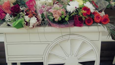Many-beautiful-flowers-on-decorative-cart