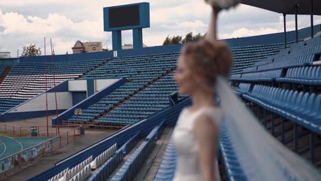Young-beautiful-bride-defocused-stands-in-the-stadium