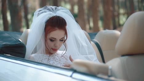 Tired-of-photo-sessions-the-bride-sits-in-a-cabriolet-close-up-slow-motion