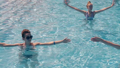 girls-are-engaged-in-water-aerobics-in-summer-Smiles