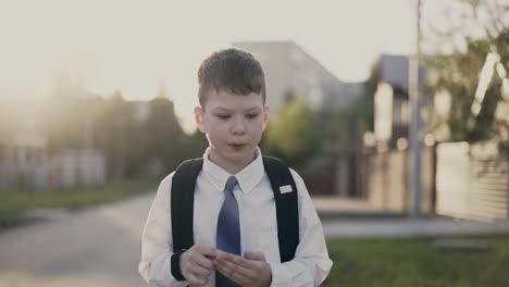 CU-Tracking-Portrait-of-schoolboy-with-knapsack-behind-his-back-in-school-uniform-He-counts-on-his-fingers
