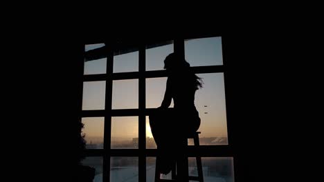 silhouette-of-stressed-woman-in-darkness-against-sunset