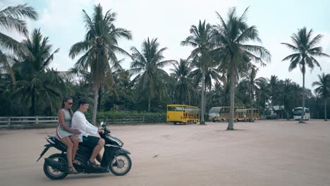 girl-and-man-appear-on-asphalt-square-riding-motorbike