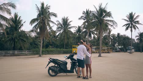 man-gets-off-motorbike-approaches-girl-kisses-and-hugs
