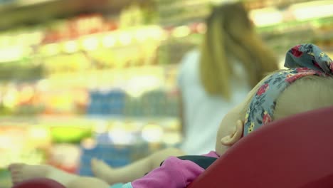 child-sits-in-a-specially-equipped-chair-5-in-the-supermarket-1