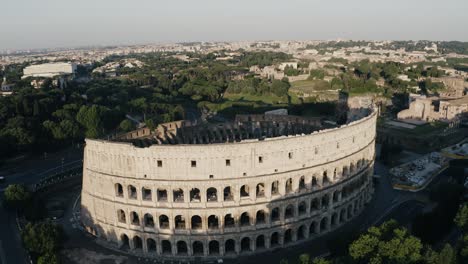 Drone-shot-tilting-up-from-the-Roman-Colosseum-to-reveal-Rome's-beautiful-land