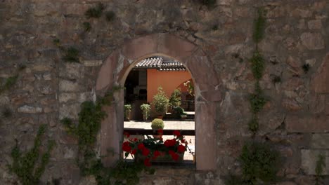 Aerial-Rising-Shot-Of-Wall-To-Reveal-Courtyard-In-Rasiglia,-A-Small-Village-Located-In-The-Province-Of-Perugia