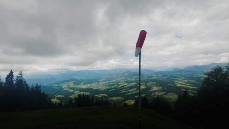 A-wind-sock-blowing-in-front-of-a-majestic-Austrian-background-with-views-of-the-alps