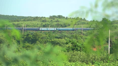 Indian-railways-train-passing-through-green-hills-in-North-Central-India