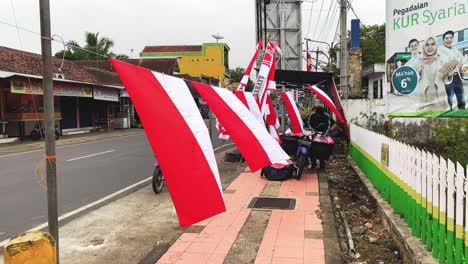 Indonesia-flag-seller-in-city-suburbs,-slow-motion-view