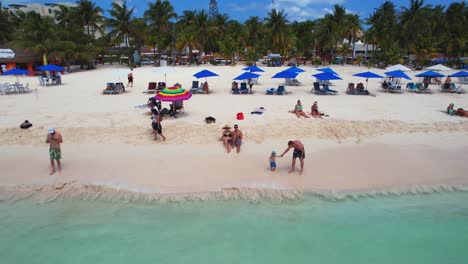 Aerial-drone-backward-view-of-beautiful-resort-in-Playa-Norte-beach,-Isla-Mujeres,-Mexico