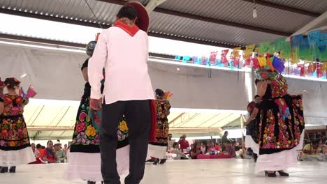 Slow-motion-shot-of-women-and-men-dancing-together-in-traditional-clothing-at-the-guelaguetza