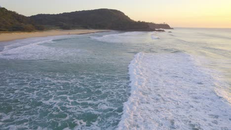 Foamy-Waves-Coming-The-Sandy-Shore-Of-Beach-During-Sunrise-In-Sunshine-Beach,-Noosa,-QLD,-Australia