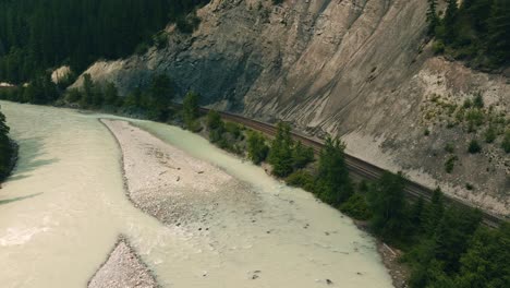 Closeup-aerial-view-of-Canadian-Pacific-railway-following-kicking-horse-river
