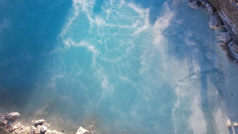 Aerial-View-of-Blue-Swimming-Pool-and-Vapor-From-Hot-Geothermal-Water,-Drone-Shot