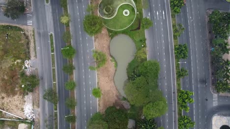 Top-down-aerial-perspective-of-large-highway-roads-and-zen-peace-symbol-in-grass-median-of-vietnam