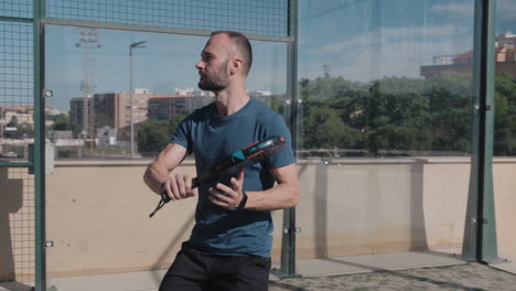 Padel-tennis-player-services-the-ball-and-does-a-drive-hand-shot
