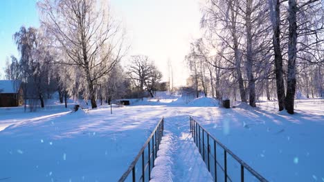 Deep-snow-layer-covering-pedestrian-bridge-during-snowfall,-tilt-up-view