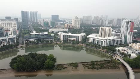 Drone-descends-above-district-7-ho-chi-minh-city-pond-water-feature