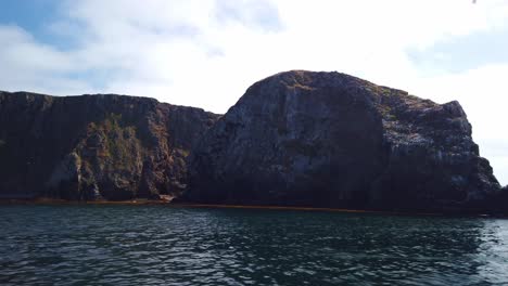 Gimbal-tilting-down-shot-from-a-moving-boat-of-the-rugged-East-Anacapa-coastline-at-Channel-Islands-National-Park,-California