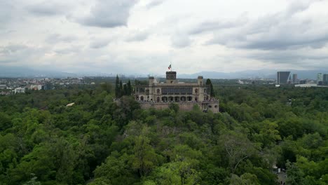 Aerial-view-of-Chapultepec-Castle-on-top-of-a-hill-with-the-surrounding-forest,-Mexico-City,-Mexico,-CDMX