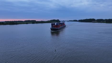 A-large-ship-with-colorful-iron-containers-carries-cargo-down-the-river