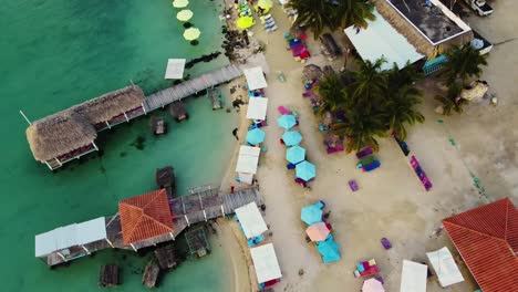 Aerial-over-the-beach-and-buildings-near-the-'Secret-Beach-Belize'-on-Ambergris-Caye-or-Bay,-Belize