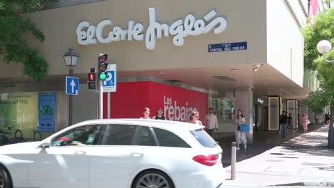 Pedestrians-wait-at-a-traffic-light-in-front-of-the-Spanish-biggest-department-store-El-Corte-Ingles-and-logo-seen-in-Spain