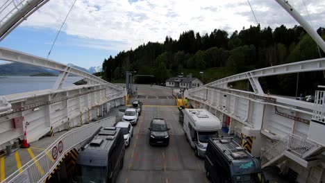 Lat-cars-driving-onboard-and-boom-closes-before-ferry-departure-from-Vestnes-to-Molde-in-Norway---Onboard-ferry-passengers-point-of-view