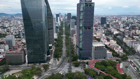 Flight-over-the-Paseo-de-la-Reforma-financial-district,-avenue-with-skyscrapers-in-Mexico-City,-you-can-see-the-Torre-Mayor,-Torre-Reforma,-Torre-BBVA,-Torre-Chapultepec-Uno,-Mexico-City,-Mexico