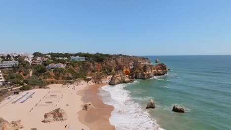 empty-sand-volleyball-courts-on-beach,-praia-dos-tres-Irmaos-Algarve,-Aerial-trucking-pan-parallax