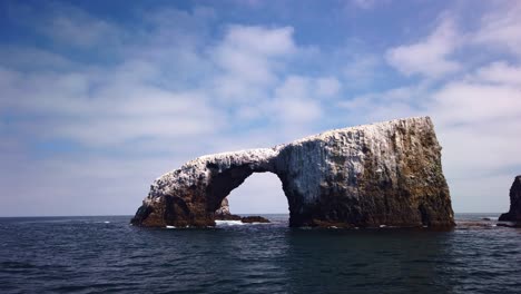 Gimbal-close-up-shot-from-a-moving-boat-approaching-the-famous-Arch-Rock-off-East-Anacapa-Island-in-Channel-Islands-National-Park,-California