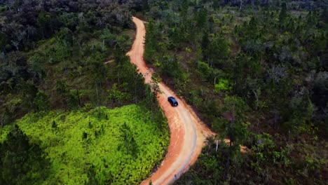 Aerial-following-a-SUV-on-dirt-roads-in-Mountain-Pine-Ridge-Forest-Reserve-in-Belize