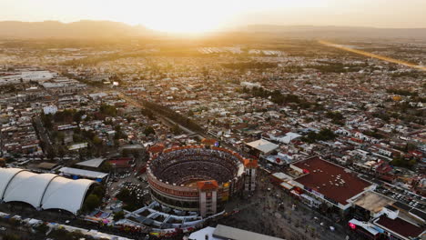 Flying-around-the-Plaza-de-Toros-stadium,-sunny-evening-in-Mexico---Aerial-view