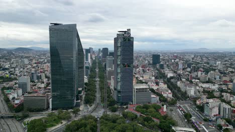 Panning-left-the-Paseo-de-la-Reforma-financial-district,-avenue-with-skyscrapers-in-Mexico-City,-you-can-see-the-Torre-Mayor,-Torre-Reforma,-Torre-BBVA,-Torre-Chapultepec-Uno,-Mexico-City,-Mexico